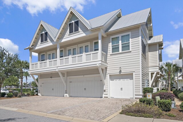 view of front of house featuring a balcony and a garage