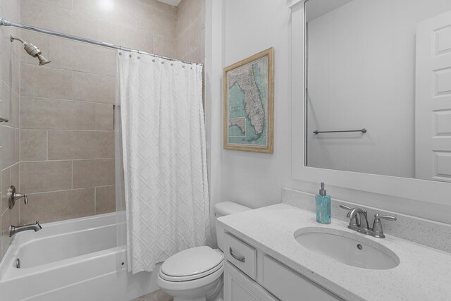 full bathroom with shower / bath combo, vanity, and toilet