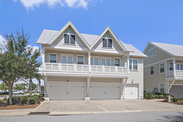 view of front of property featuring a balcony and a garage