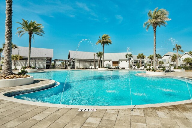 view of pool featuring pool water feature and a patio area