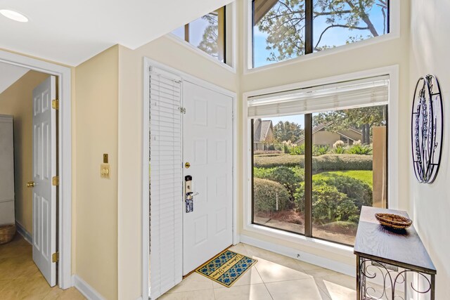 entryway featuring light tile patterned floors and a healthy amount of sunlight