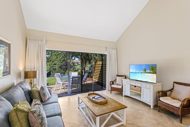 tiled living room featuring high vaulted ceiling