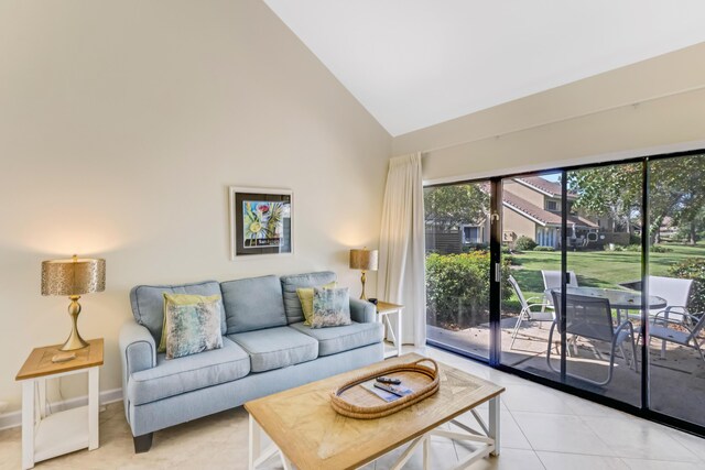 living room with light tile patterned floors and high vaulted ceiling