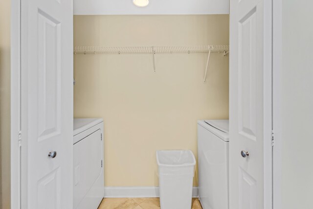 laundry area featuring light tile patterned floors and washing machine and dryer