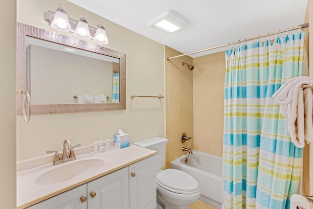 full bathroom featuring toilet, vanity, and shower / tub combo with curtain