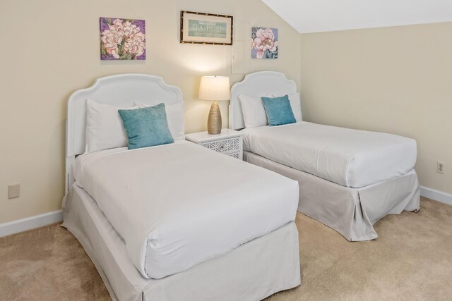 bedroom featuring light carpet and lofted ceiling