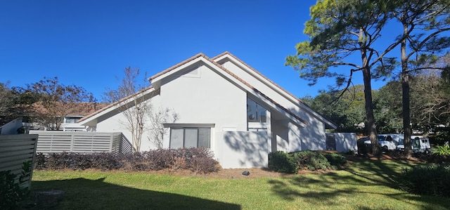 view of home's exterior with a yard