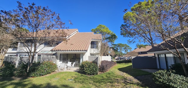 view of home's exterior featuring a lawn and a patio