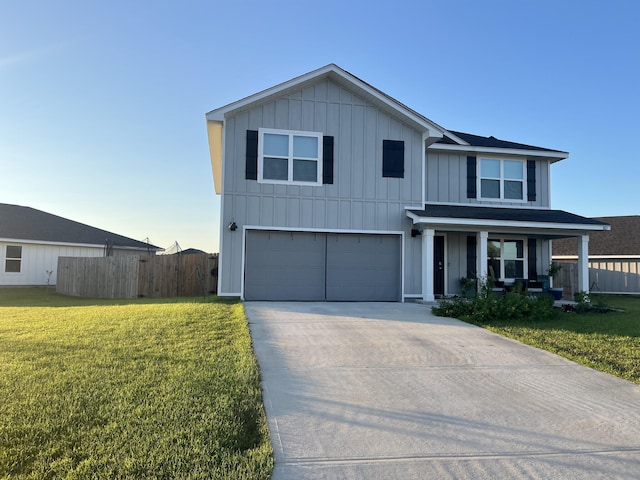 view of front of home with a garage, a front lawn, and covered porch