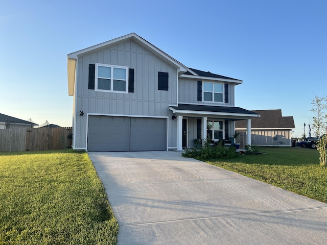 view of front of property with a garage, covered porch, and a front yard