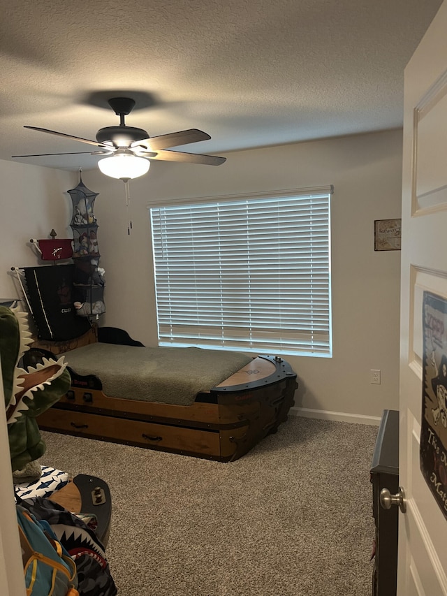 carpeted bedroom with a textured ceiling and ceiling fan