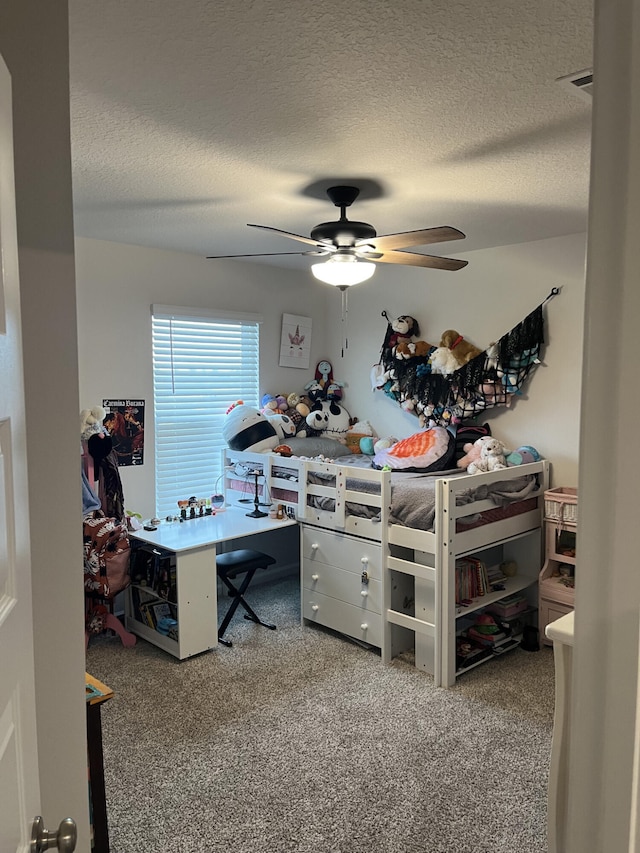 bedroom featuring carpet floors, a textured ceiling, and ceiling fan