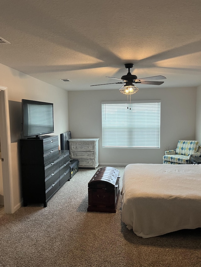 carpeted bedroom with a textured ceiling and ceiling fan