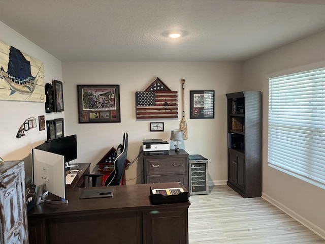 office space with a textured ceiling and light hardwood / wood-style floors