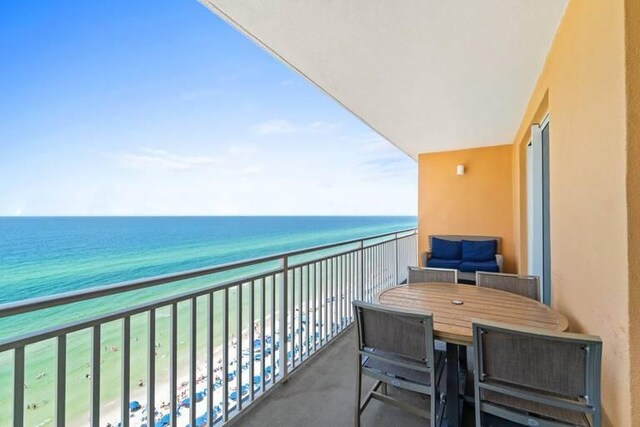 balcony with a view of the beach and a water view