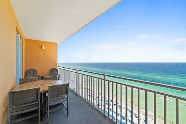 balcony with a view of the beach and a water view