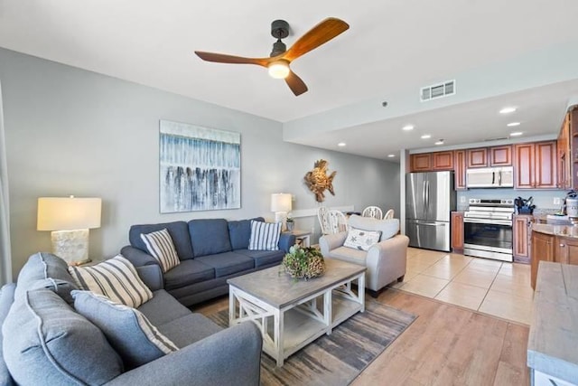 living room featuring light wood-type flooring and ceiling fan