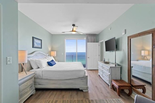 bedroom featuring access to outside, light hardwood / wood-style flooring, and ceiling fan