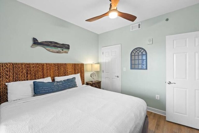 bedroom with ceiling fan and hardwood / wood-style flooring