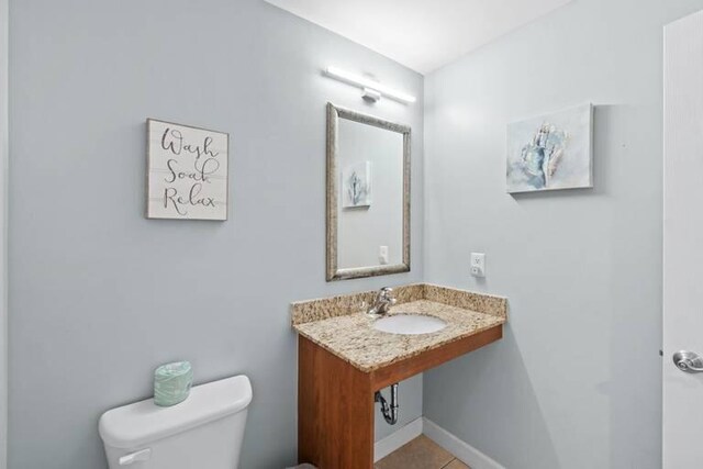 bathroom with sink, tile patterned flooring, and toilet