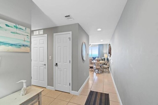 hall with light tile patterned floors