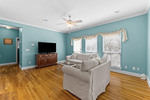 living room featuring light hardwood / wood-style flooring, ceiling fan, and ornamental molding