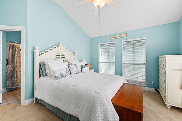 bedroom with ceiling fan, light colored carpet, and lofted ceiling