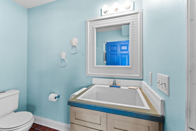 bathroom featuring vanity, toilet, and tile patterned floors