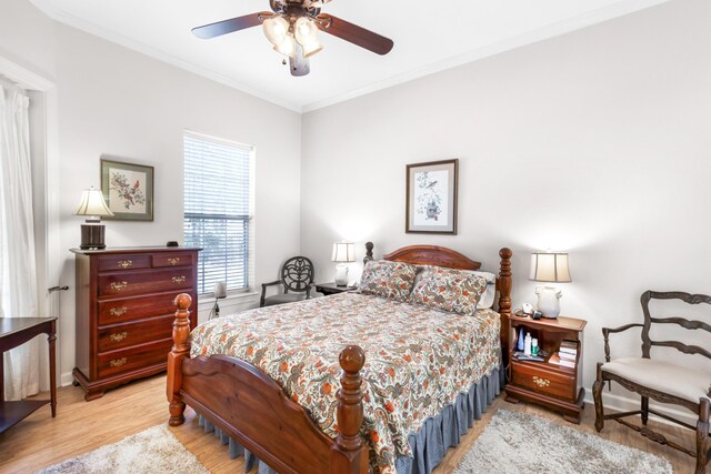 bedroom with ornamental molding, light hardwood / wood-style flooring, and ceiling fan