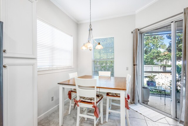 dining room with light tile patterned floors, a notable chandelier, and ornamental molding