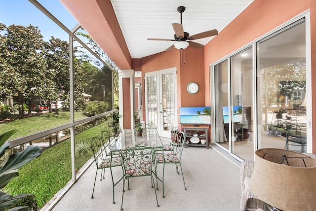 sunroom / solarium featuring ceiling fan