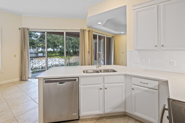 kitchen featuring stainless steel appliances, white cabinets, kitchen peninsula, sink, and ornamental molding