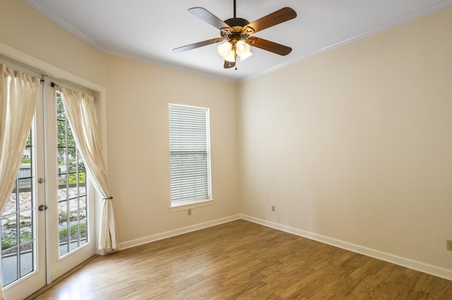 unfurnished room featuring french doors, light hardwood / wood-style floors, and crown molding