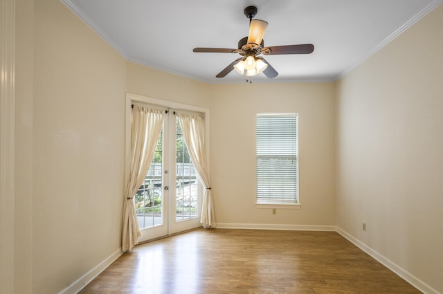 spare room featuring french doors, light wood-type flooring, and ornamental molding