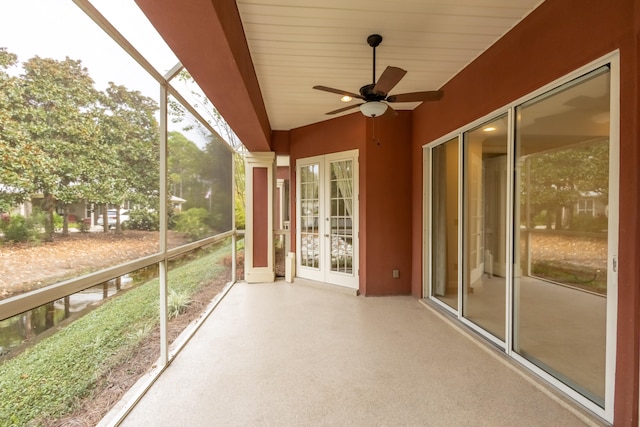 unfurnished sunroom with wooden ceiling, ceiling fan, and french doors