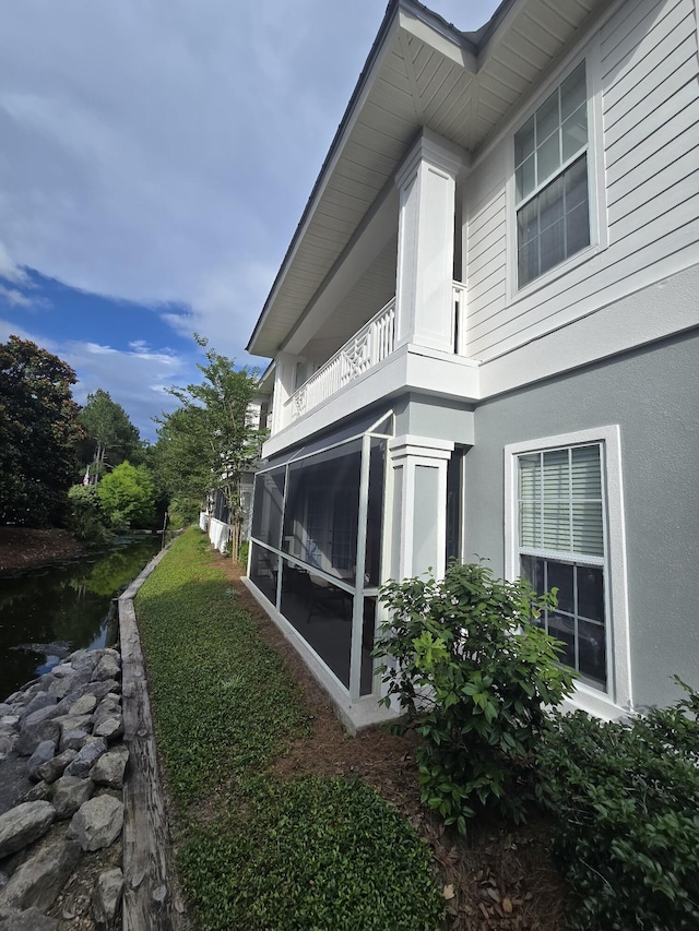 2252 Crystal Cove Ln Unit 2252, Miramar Beach, FL 32550 - view of side of property with a balcony, stucco siding, and a sunroom