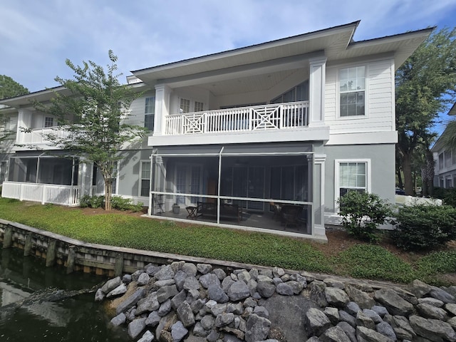 2252 Crystal Cove Ln Unit 2252, Miramar Beach, FL 32550 - back of house with a balcony, a sunroom, and a yard