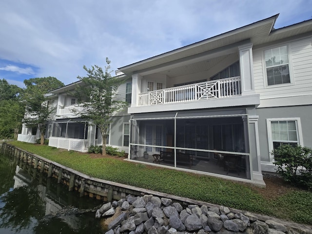 2252 Crystal Cove Ln Unit 2252, Miramar Beach, FL 32550 - rear view of house featuring a balcony, a sunroom, and a lawn