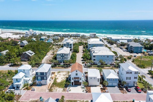 drone / aerial view with a water view and a beach view