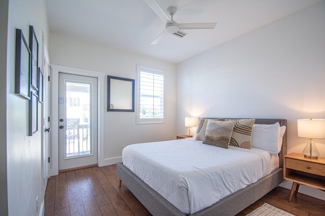 bedroom with ceiling fan, dark wood-type flooring, and access to exterior