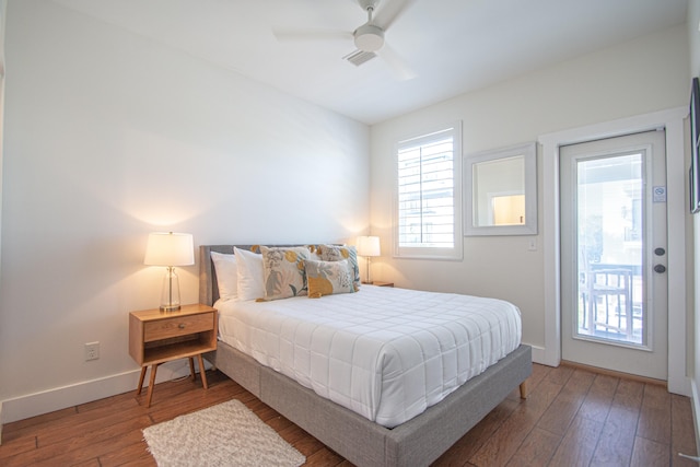 bedroom featuring ceiling fan, access to exterior, and dark wood-type flooring