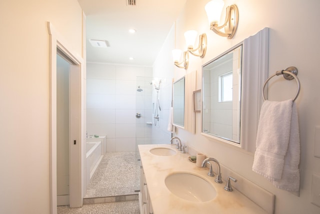 bathroom with vanity and separate shower and tub