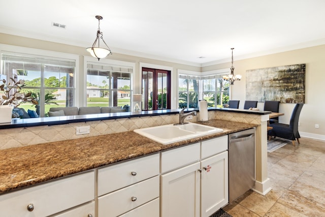 kitchen featuring white cabinets, sink, decorative light fixtures, dishwasher, and dark stone countertops