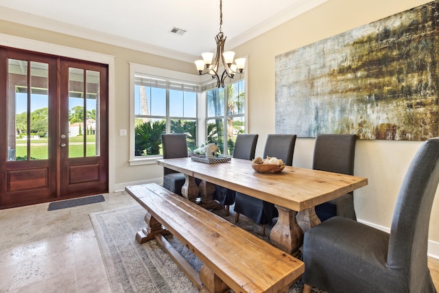 dining room featuring french doors, a notable chandelier, and ornamental molding