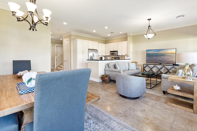 living room featuring ornamental molding and an inviting chandelier