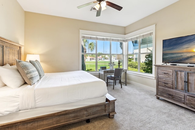 bedroom with ceiling fan and light colored carpet