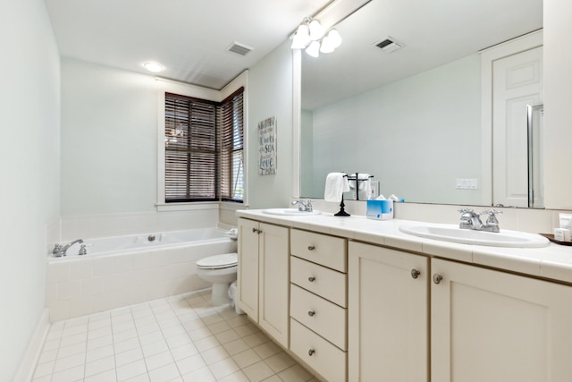 bathroom featuring tiled bath, toilet, vanity, and tile patterned floors