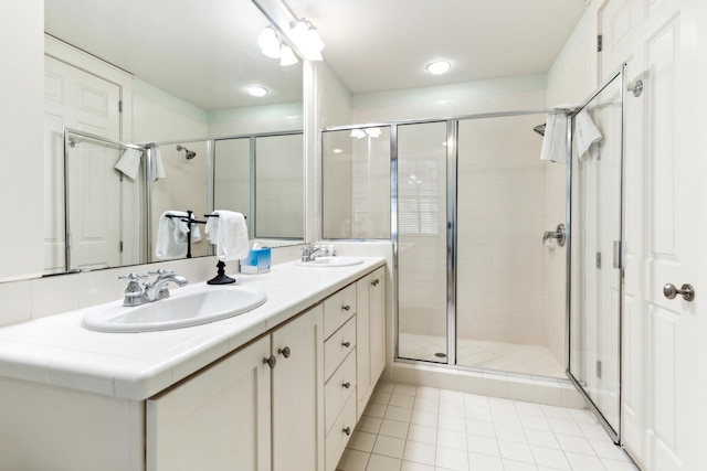 bathroom featuring tile patterned flooring, vanity, and an enclosed shower