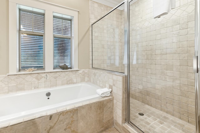 bathroom featuring shower with separate bathtub