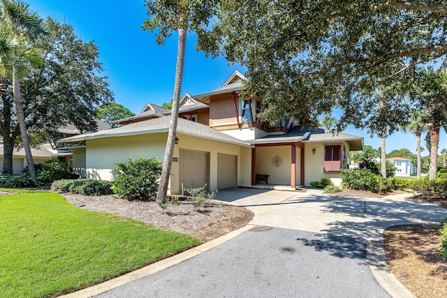 view of front of property with a garage and a front lawn